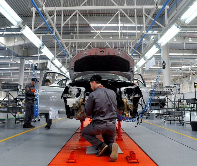 A person working on a half assembled car