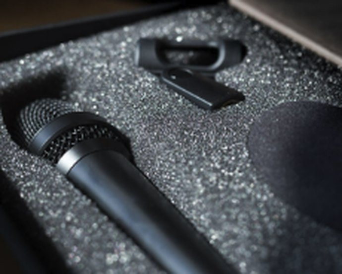 Microphone and accessories seated in a die-cut protective polyethylene foam insert